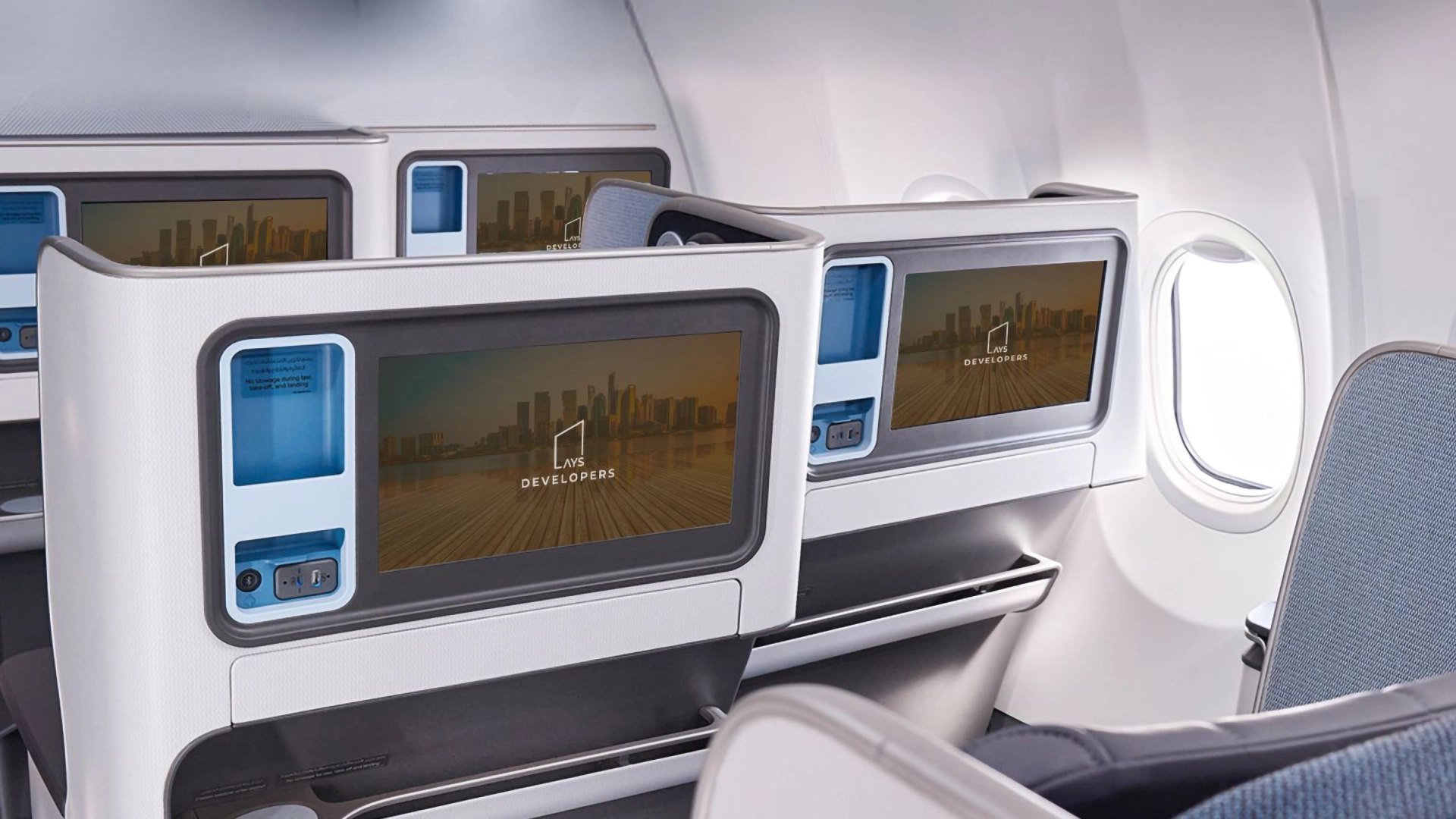 The business class seats on Emirates Airlines showing advertsing for AYS Developers
