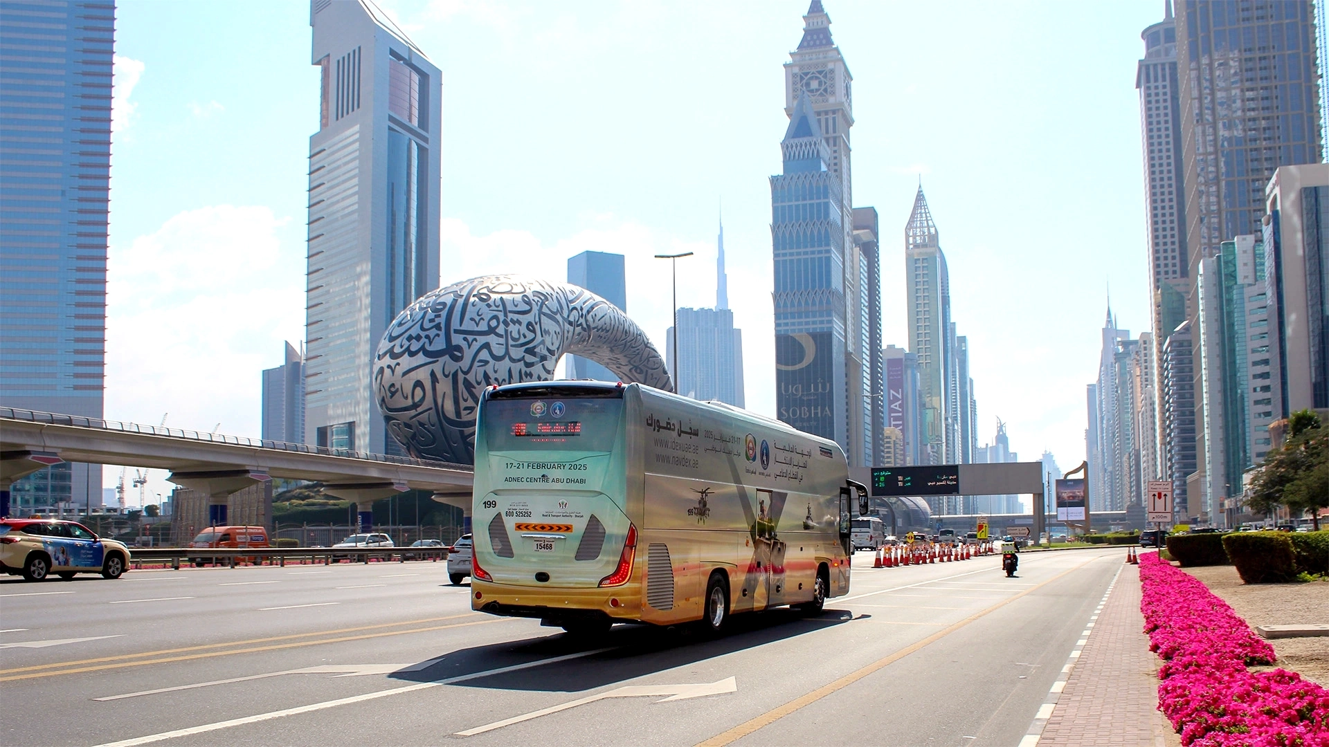 A fully-wrapped bus passes by the Museum of the Future on Sheikh Zayed Road in Dubai