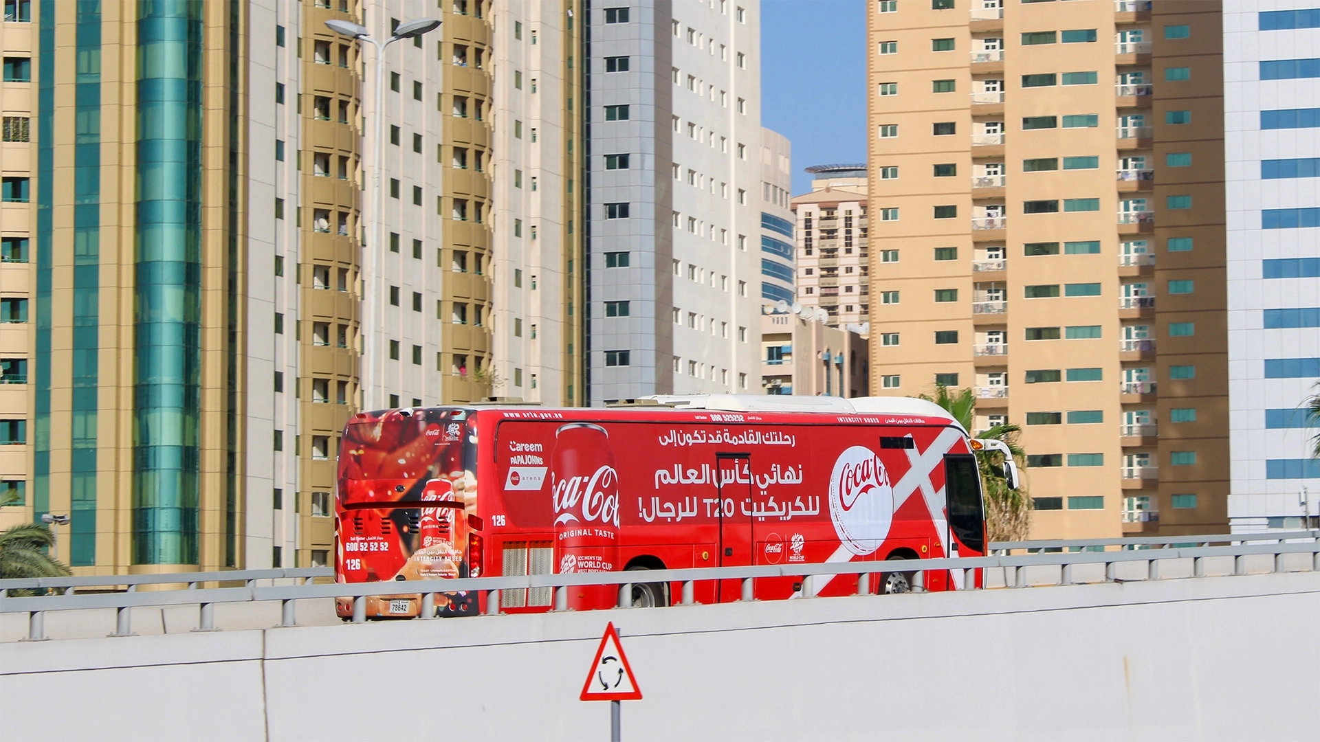 A co-branded bus in Coca-Cola’s unmistakable livery with Papa Johns and Careem drives through Dubai