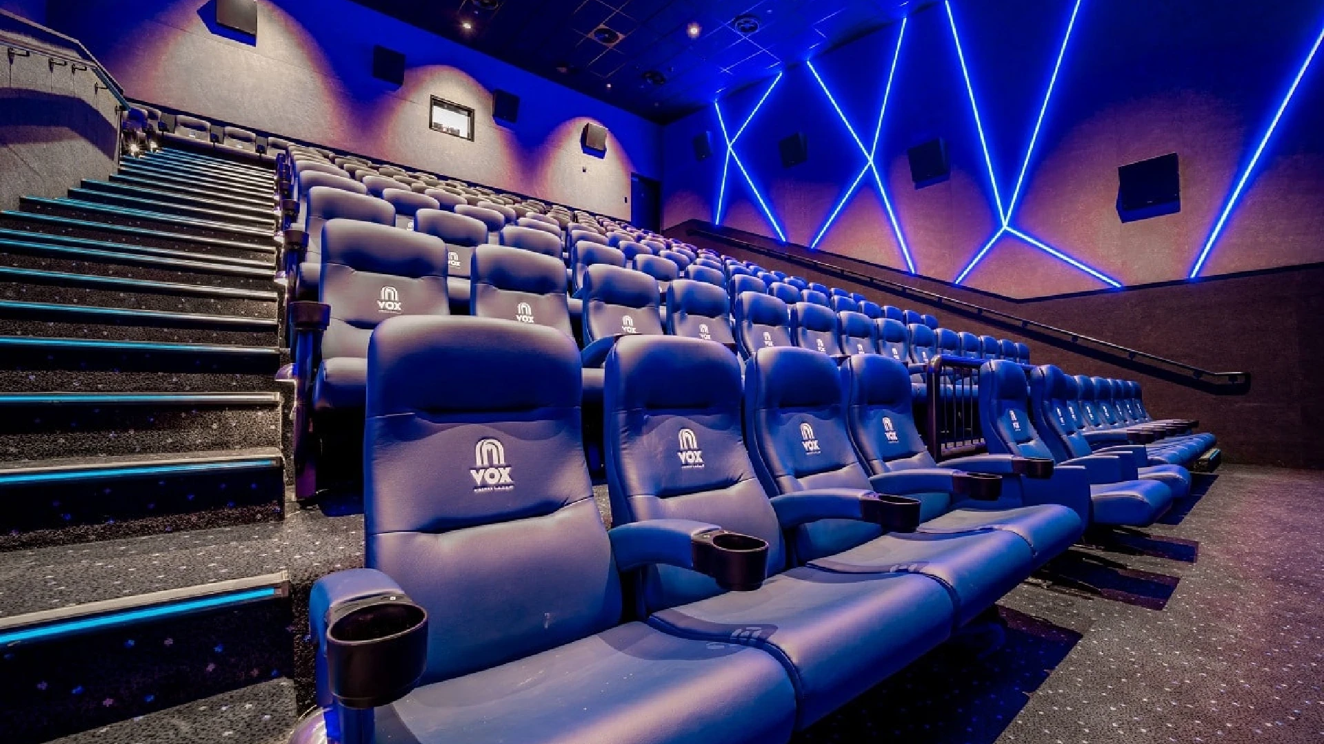 People entering a cinema with visible branded lobby ads