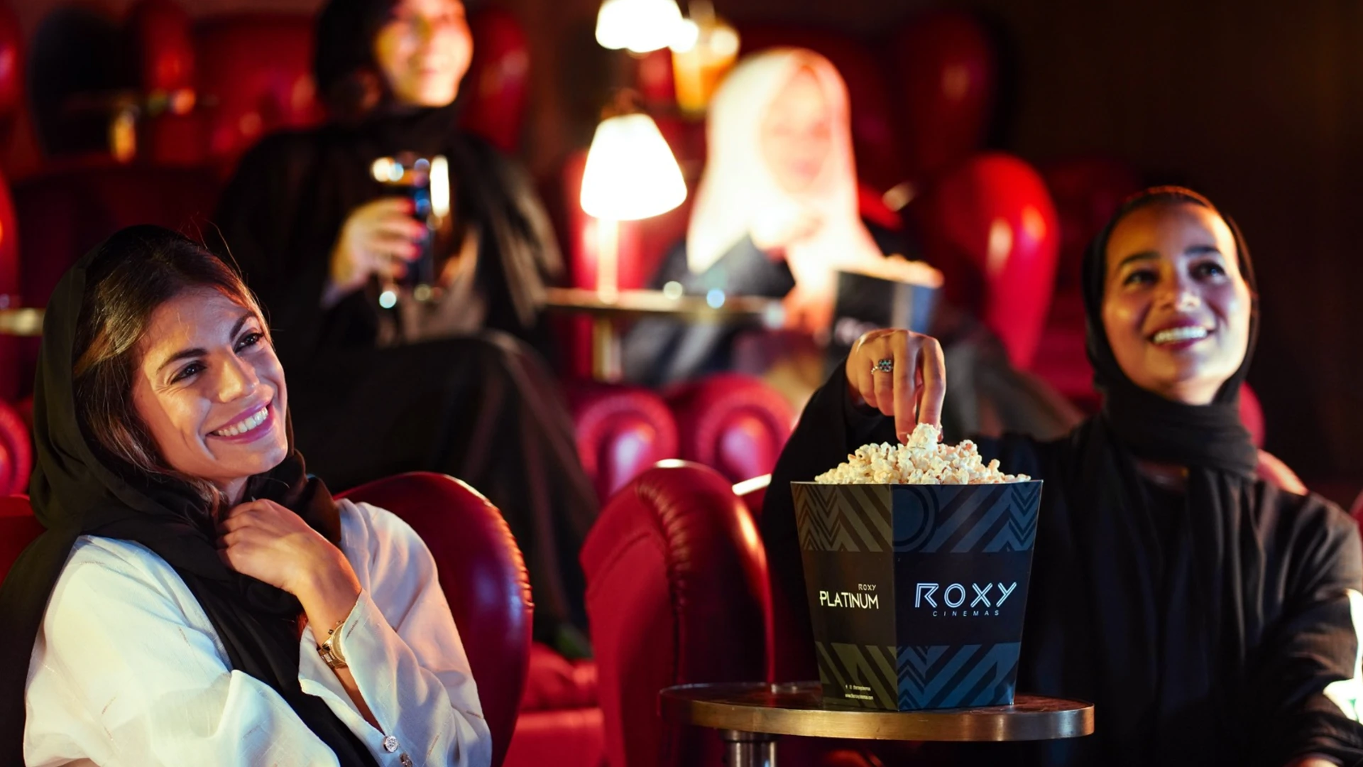 A luxury cinema with branded seating and immersive ad visuals