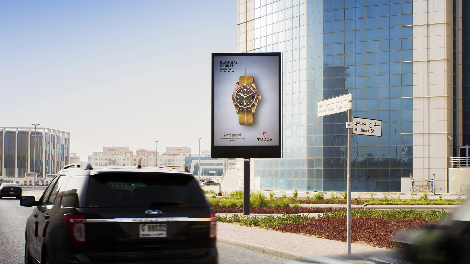 A digital billboard for Tudor watches shown in an urban neighbourhood Dubai