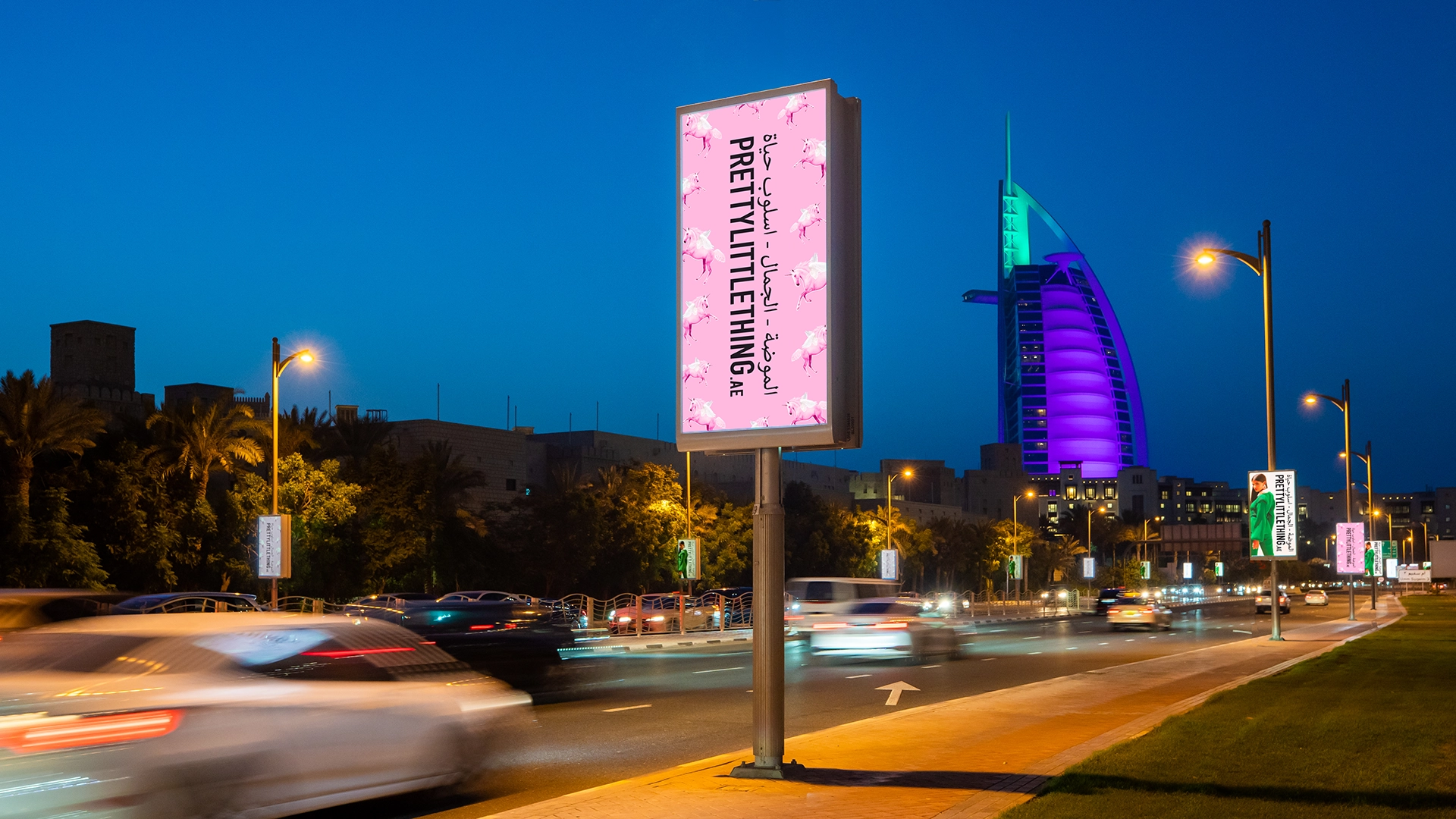 A lamppost advert for Pretty Little Thing with the Burj Al Arab in the background
