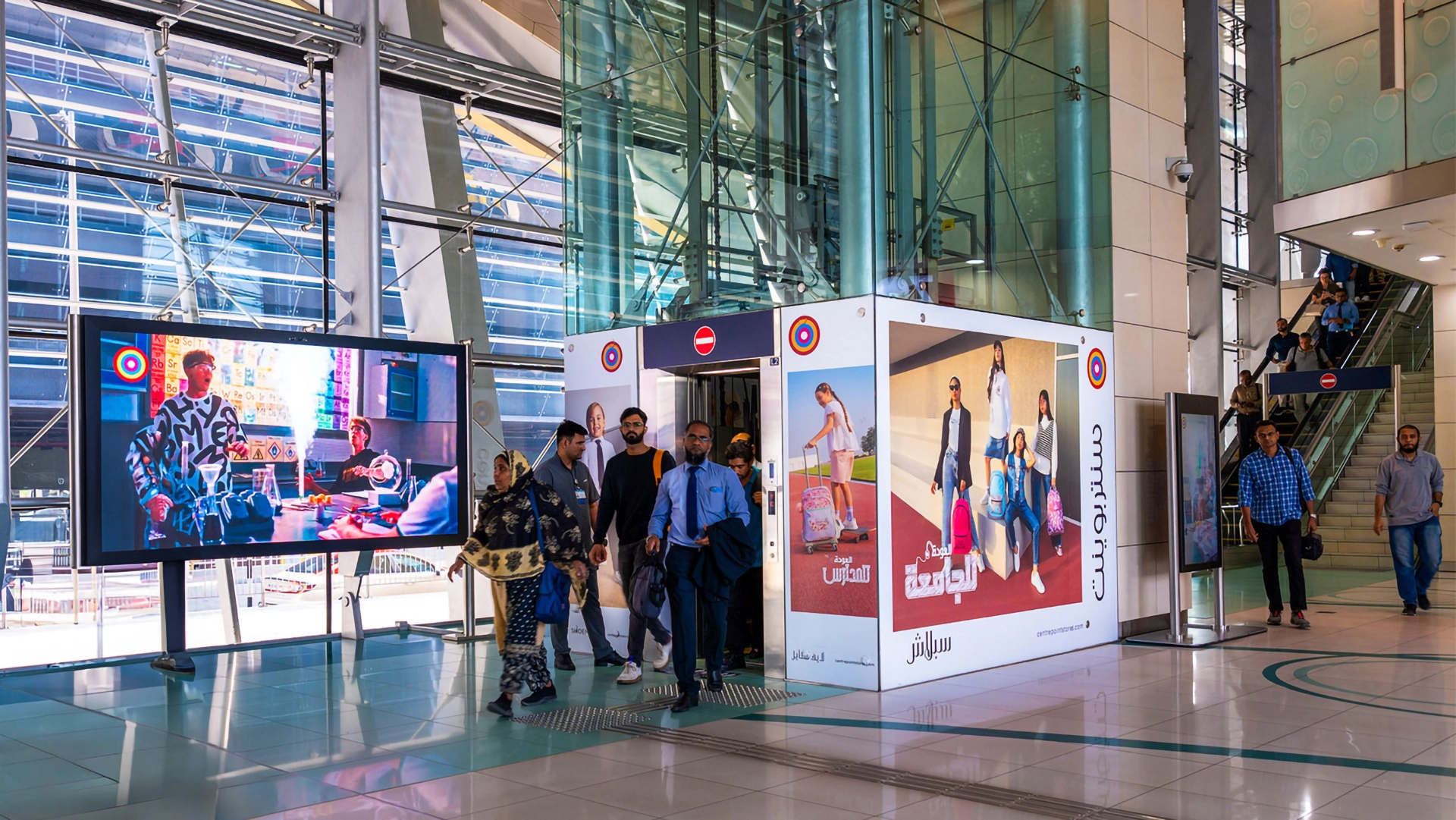 A lift vestibule and complimentary digital screen branded for Centrepoint at a Dubai Metro station
