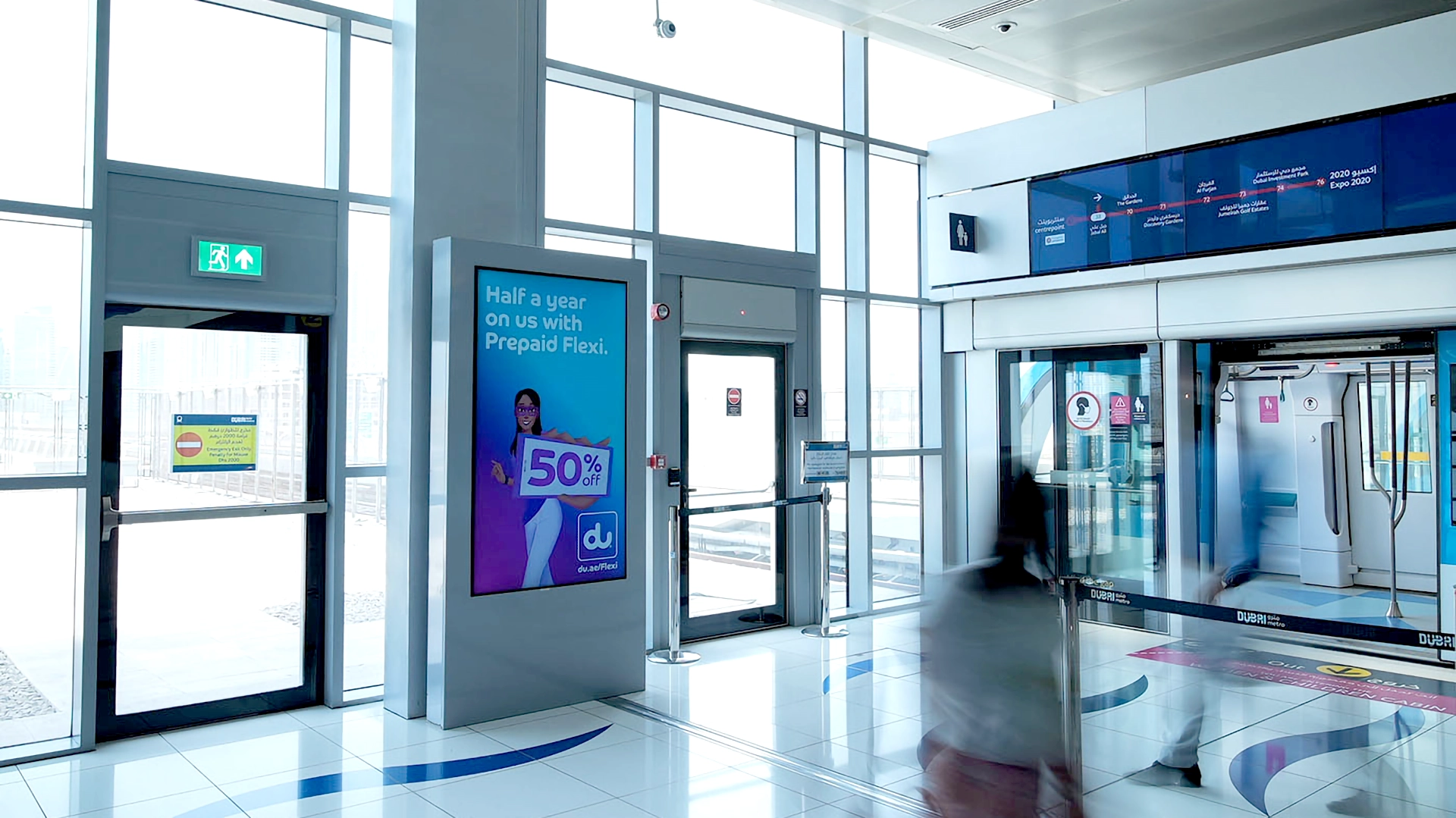 A platform level digital screen at a Dubai Metro station showing an advert for du