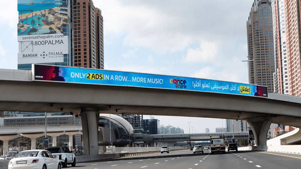 Bridge banner on Al Khail Road with automotive advertising
